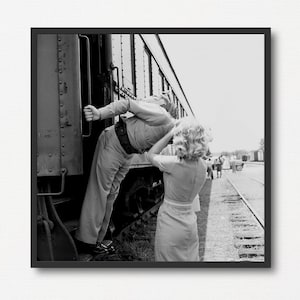 Una chica rubia y un soldado se dan un beso de despedida en una estación de tren. Impresión fotográfica vintage en blanco y negro. Regalo de San Valentín. Fotografía antigua de despedida.