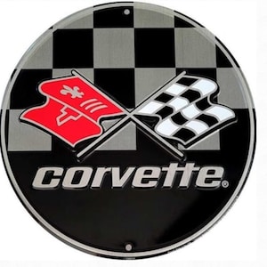 May include: A round metal sign with a black and silver checkered background.  Two crossed flags are in the center, one red with a fleur-de-lis and the other black and white checkered. The word "corvette" is written in silver below the flags.