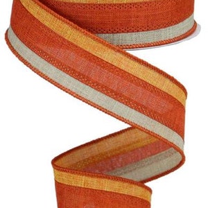 May include: A 2.5 inch wide orange, beige, and gold striped ribbon with a textured woven design. The ribbon is made of a burlap-like material.