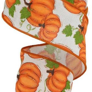 May include: A roll of white wired ribbon with a repeating pattern of orange pumpkins with green leaves. The ribbon has a brown edge.