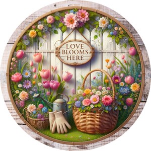May include: A white picket fence with a sign that reads "Love Blooms Here" surrounded by a variety of colorful flowers in a garden setting. A wicker basket filled with flowers sits in front of the fence.