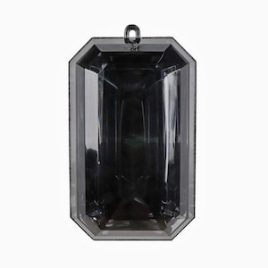 May include: A faceted, rectangular, dark gray translucent pendant with a smooth, polished surface and a small, integrated loop at the top center for attachment. The geometric design features multiple angled edges that reflect light.