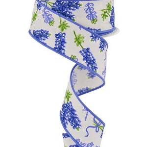May include: White ribbon with a blue border and a floral print of purple bluebonnets.