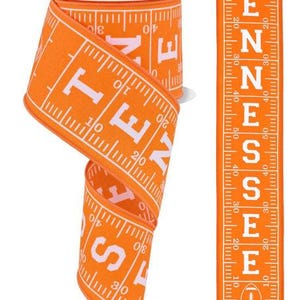 May include: Orange and white ribbon with a repeating pattern of a ruler with the word "TENNESSEE" printed on it. The ribbon is 2.5 inches wide.