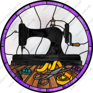 May include: A stained glass depiction of a vintage sewing machine with a spool of thread, scissors, and buttons on a wooden table. The image is framed in a purple and white circle.