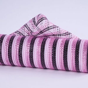 May include: A roll of pink, black, and white striped mesh ribbon with a matching plaid accent. The ribbon is tightly rolled, with a portion of the plaid material folded over the top. This decorative mesh is suitable for crafting and decorating.
