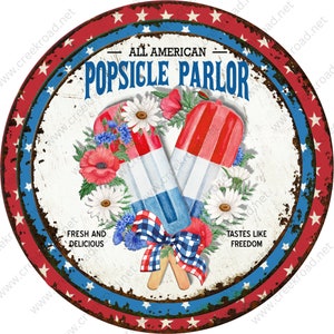 May include: A red, white, and blue popsicle parlor sign with a distressed, vintage look. The sign features two crossed popsicles with red, white, and blue stripes, surrounded by flowers. The text "All American Popsicle Parlor" is written in a bold, white font.