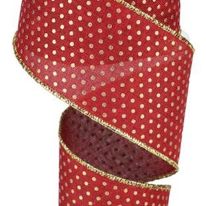 May include: A spool of red ribbon with gold polka dots and a gold trim. The ribbon is made of a textured material and is ideal for crafting, gift wrapping, or holiday decorations. The ribbon is approximately 2.5 inches wide.