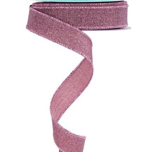 May include: A roll of mauve ribbon with a shimmery finish. The ribbon has a subtle texture and is perfect for adding a touch of elegance to any project.
