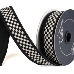 May include: A spool of black and white checkered ribbon with solid black edges. The ribbon is wrapped around a dark circular spool featuring the white text Farrisilk in a cursive font. The fabric ribbon has a repeating small square pattern.