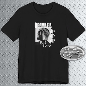 May include: Black t-shirt with a white graphic print of a man's face with the text "jpegMAFIA" and "マイク" printed below the image.