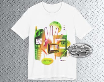 May include: White t-shirt featuring a digital art design with green and orange elements. The design includes a green cell phone, an eye, a hand, and a small screen. A silver oval emblem is on the right side.