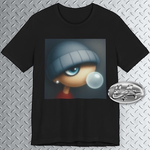 May include: Black t-shirt featuring a cartoon character with a blue beanie, large blue eyes, and a bubblegum bubble. The character is wearing a red shirt and a silver earring. A silver emblem is on the right side of the shirt.