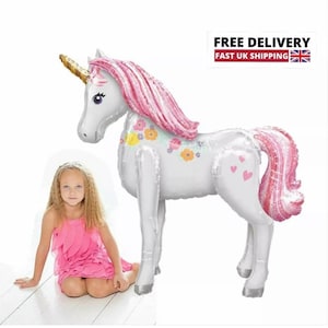 May include: A large white unicorn balloon with pink mane and tail, decorated with flowers. The balloon is standing on a white surface.