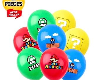 May include: A collection of colorful balloons featuring iconic video game imagery. The balloons are red, green, blue, and yellow, with graphics of a mushroom, question mark, and the character Mario. The balloons are labeled "Happy Birthday" and "1UP".