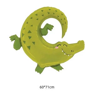 May include: Green alligator shaped foil balloon with a smiling face and a white background. The balloon is 60 inches by 71 inches.