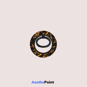 May include: A round phone grip with a black ring and a tortoiseshell pattern. The grip has a black ring that swivels. The text "AesthePoint" is at the bottom of the image.