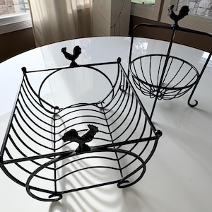 May include: A black metal fruit bowl and dish rack set with rooster accents. The bowl is suspended from a stand and the dish rack is curved.