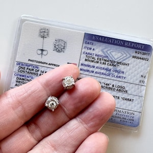 Pair Stamped 14K white gold & approximate 18 natural diamond weighing .95-1.02 carat(s)  mounted stud earrings + IGI certificate No backing