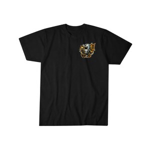 May include: Black t-shirt with a small, detailed graphic on the chest. The graphic features a welding mask, sparks, and a banner. The design incorporates shades of gold, orange, and silver.