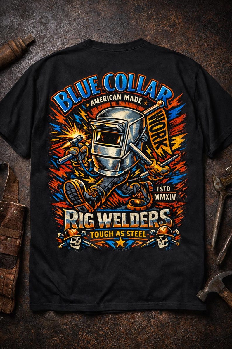 May include: Black t-shirt featuring a colorful graphic of a welding figure with a welding mask, holding tools. The design includes the text "Blue Collar Work" and "Rig Welders, Tough as Steel."