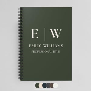 May include: A dark green spiral bound notebook with the initials "E|W" and the name "Emily Williams" and the text "Professional Title" in white.