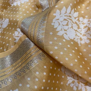 Pure Chanderi silk cotton saree pastel yellow with white polka dot and silver zari border running blouse plain.