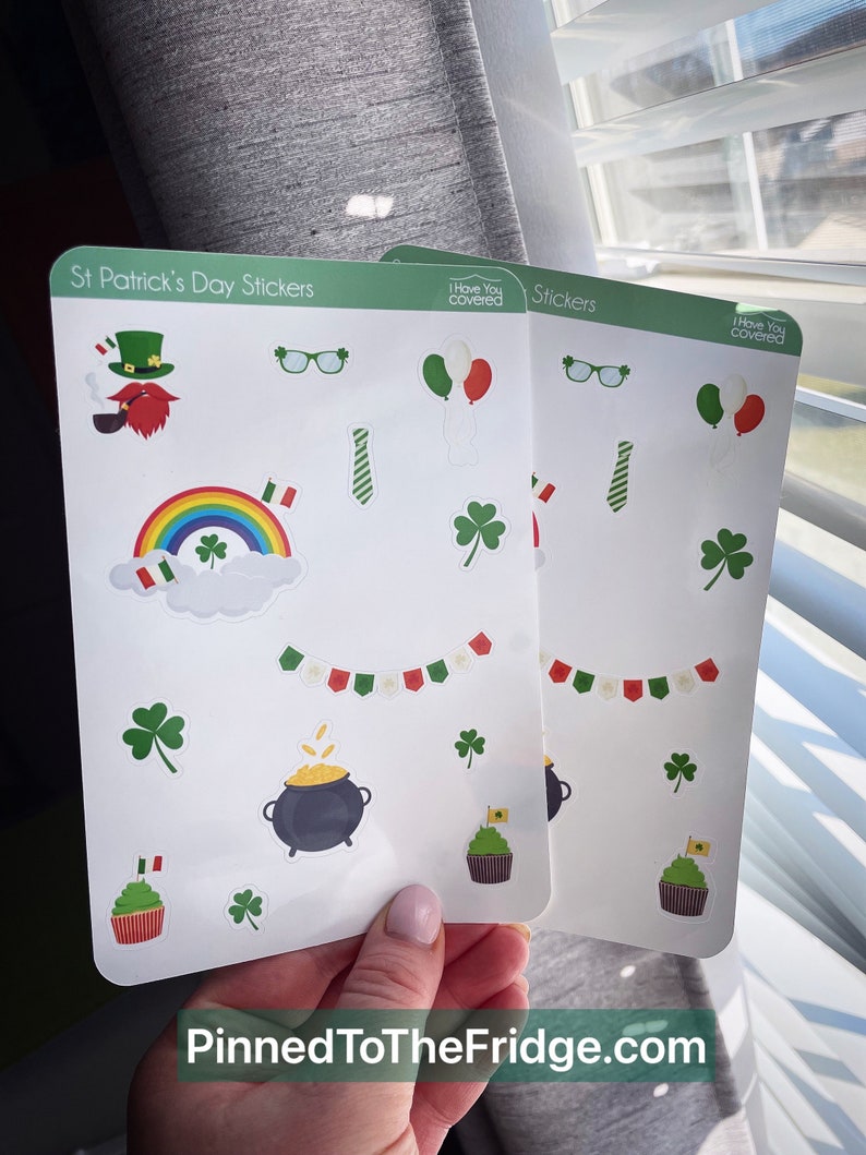 May include: Two sticker sheets with St. Patrick's Day themed designs. The stickers include a leprechaun, rainbow, shamrocks, pot of gold, cupcakes, and balloons. The text "Pinned ToTheFridge.com" is at the bottom.