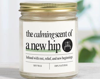 May include: A white candle jar with a gold lid. The label reads "the calming scent of a new hip" and "Infused with rest, relief, and new beginnings". The label also says "Soy Wax" and "100% Natural".
