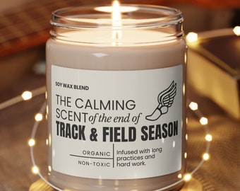 May include: A soy wax candle with a brown label that reads "The Calming Scent of the end of Track & Field Season". The label also says "Organic, Non-Toxic" and "Infused with long practices and hard work".