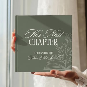 May include: A square, sage green hardcover book featuring white text that reads "Her Next CHAPTER LETTERS FOR THE Future Mrs. Lowell" alongside a white line-art illustration of an open book with floral elements emerging from the pages.