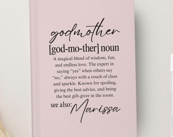 May include: A pink notebook with the word "godmother" defined as a magical blend of wisdom, fun, and endless love. The text also says "see also: Marissa".