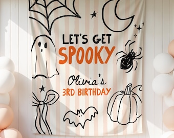 May include: A rectangular fabric backdrop featuring a light beige and white vertical striped pattern. The text reads LET'S GET SPOOKY, Olivia's 3RD BIRTHDAY. Illustrations include a ghost, spider web, crescent moon, spider, bat, and pumpkin.