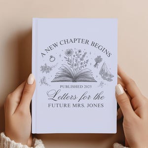 May include: A light purple book with the text "A New Chapter Begins" and "Letters for the Future Mrs. Jones" in elegant script. The cover features an open book with floral illustrations and the year "Published 2025".