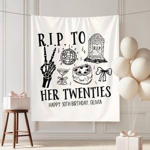 May include: White banner with black text and illustrations for a 30th birthday. The banner reads "R.I.P. TO HER TWENTIES" with a skeleton hand, disco ball, tombstone, cake, and bow. The text "HAPPY 30TH BIRTHDAY, OLIVIA" is also included.