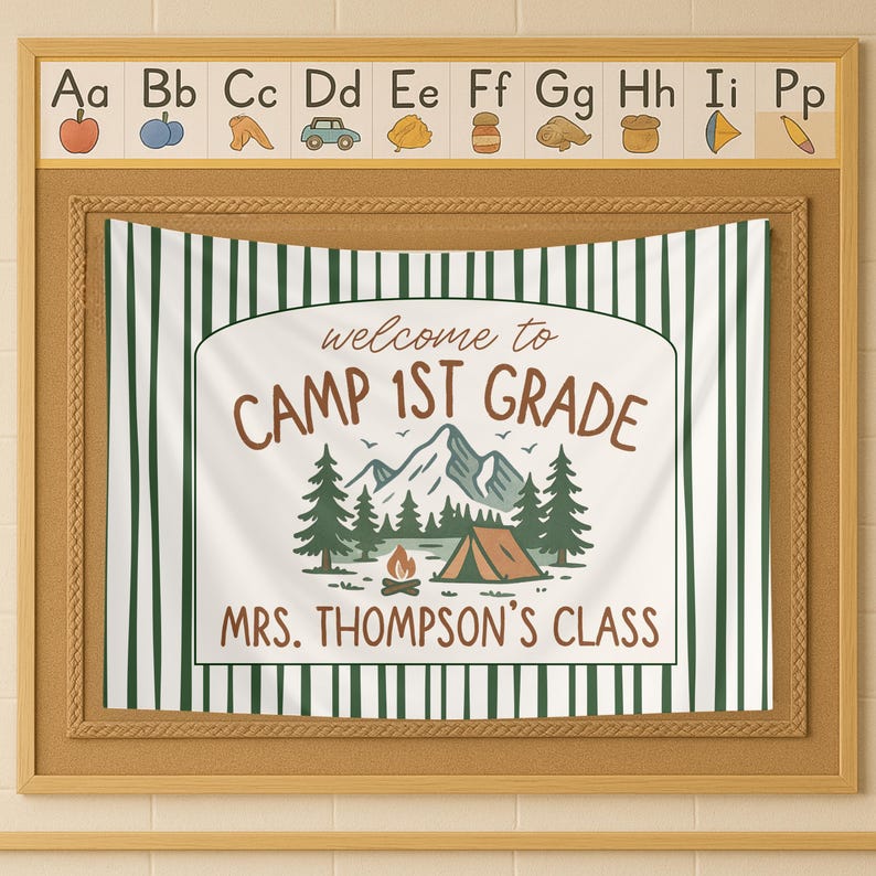 May include: A white and green striped banner with the text "welcome to CAMP 1ST GRADE MRS. THOMPSON'S CLASS" in brown lettering. The banner features a cartoon illustration of a mountain range, trees, a campfire, and a tent.