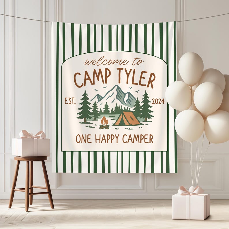 May include: A white and green striped backdrop with the text "welcome to CAMP TYLER EST. 2024 ONE HAPPY CAMPER". The backdrop features a mountain scene with a tent, trees, and a campfire.