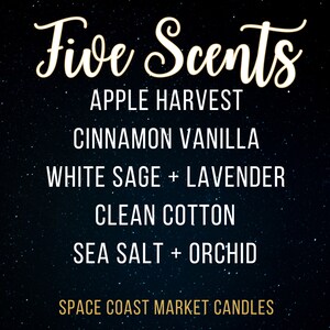 May include: A black background with white stars and gold text that reads "Five Scents" and lists five candle scents: Apple Harvest, Cinnamon Vanilla, White Sage + Lavender, Clean Cotton, and Sea Salt + Orchid. The text "Space Coast Market Candles" is at the bottom of the image.