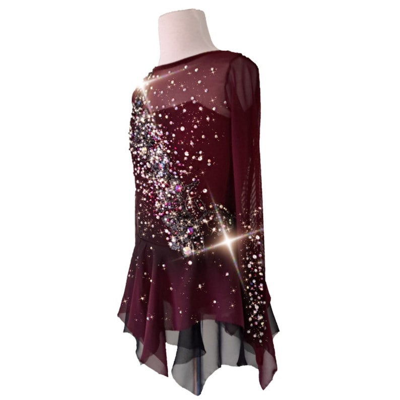 A new figure skating dress "Carmine" for performances and competitions. The dress is made in the ombre technique and hand-painted with an airbrush from carmine red to deep mahogany! Left side view
