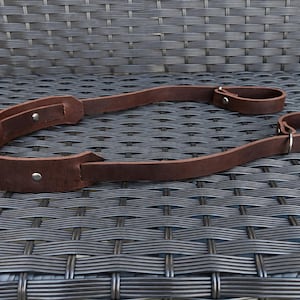 May include: A white ceramic mug with a black handle and the text "But First, Coffee" in a handwritten style. The mug is on a white surface. The mug is approximately 4 inches tall.