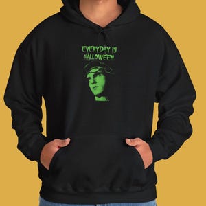 May include: Black hoodie with a green graphic print of a person with a crown of thorns and the text "EVERYDAY IS HALLOWEEN".