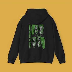 May include: Black hooded sweatshirt with a green graphic print of skeletons in coffins and the text "TYPE O NEGATIVE" on the back.
