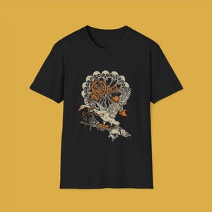 May include: Black t-shirt with a graphic print of a white swan with a fish in its beak. The graphic also includes a circle of skulls and the word "Opeth" in orange.