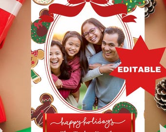May include: A holiday card featuring a family portrait inside an oval frame, surrounded by festive cookie illustrations and a red ribbon. The card includes the text "happy holidays" and "The Taylor Family" in a red banner, with an "EDITABLE" star.