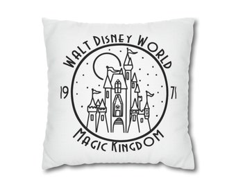 May include: White square pillow with a black line drawing of a castle inside a circle. The words "WALT DISNEY WORLD MAGIC KINGDOM 1971" are printed around the castle.