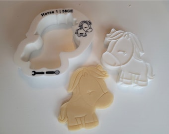 May include: White plastic cookie cutter in the shape of a horse with the text "Horse 1 | 58CE" on the top. Two additional horse-shaped cookie cutters are shown, one white and one beige.