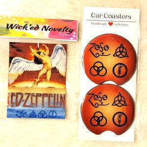 May include: Two car coasters with a brown and orange gradient background. The coasters feature black and white images of the Led Zeppelin logo, the Zoso symbol, and the band's other symbols. The text "Car Coasters" is printed on a white label above the coasters. The text "Handmade with love" is printed below the text "Car Coasters".