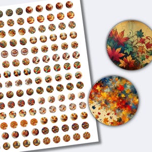 May include: A sheet of small, circular stickers with autumnal designs, including leaves and floral patterns in warm colours. Two larger, round designs with leaf art are also shown. The stickers are suitable for crafting and seasonal projects.