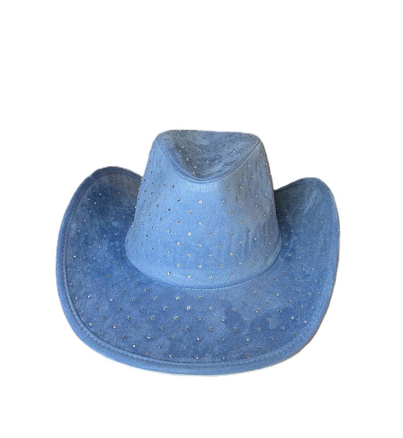 May include: A light blue cowboy hat with a suede-like texture. The hat is adorned with small, sparkling embellishments across the crown and brim. The hat has a classic cowboy hat shape with a rounded crown and a wide, curved brim.