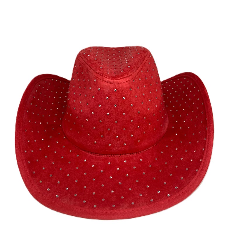 May include: A red cowboy hat with a velvet texture and small, silver-colored embellishments. The hat has a classic western design with a wide brim and a rounded crown. This hat is a stylish accessory.